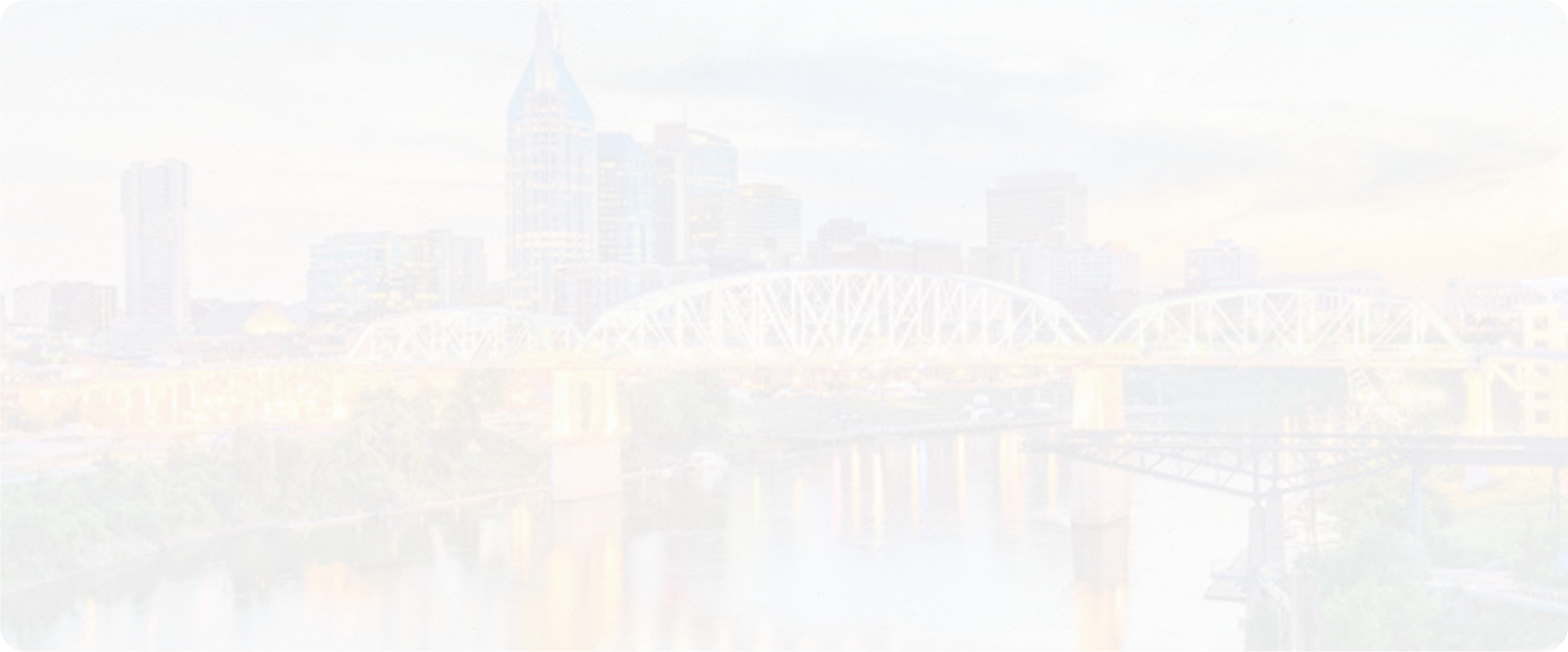 Panoramic view of downtown Nashville, Tennessee, at sunset featuring the John Seigenthaler Pedestrian Bridge and city skyline reflecting over the Cumberland River — the heart of country music and Dolly Parton’s hometown state.